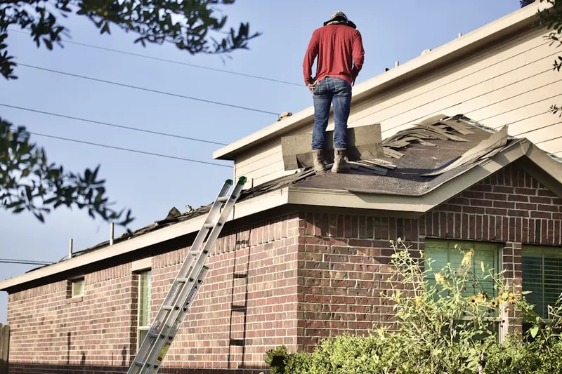 Professional roofer working on a residential roof in St. Anthony